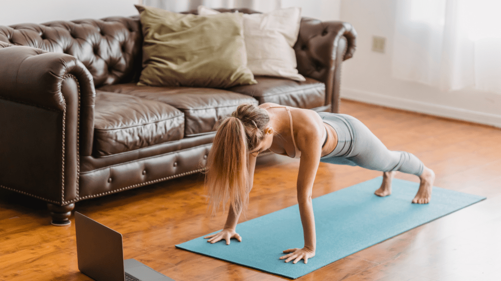 A person is doing push ups on a yoga mat