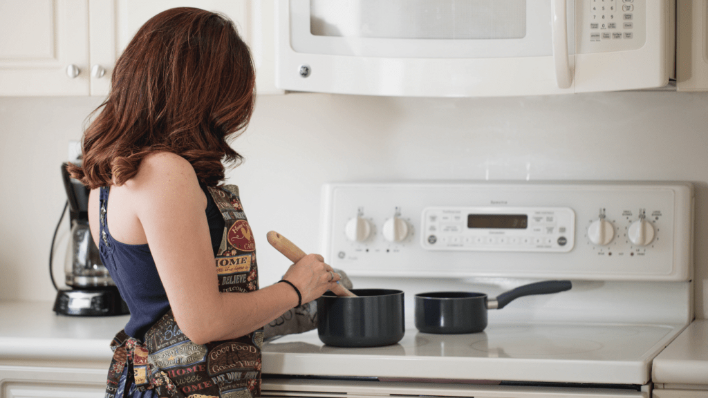 a person in an apron is cooking in the kitchen