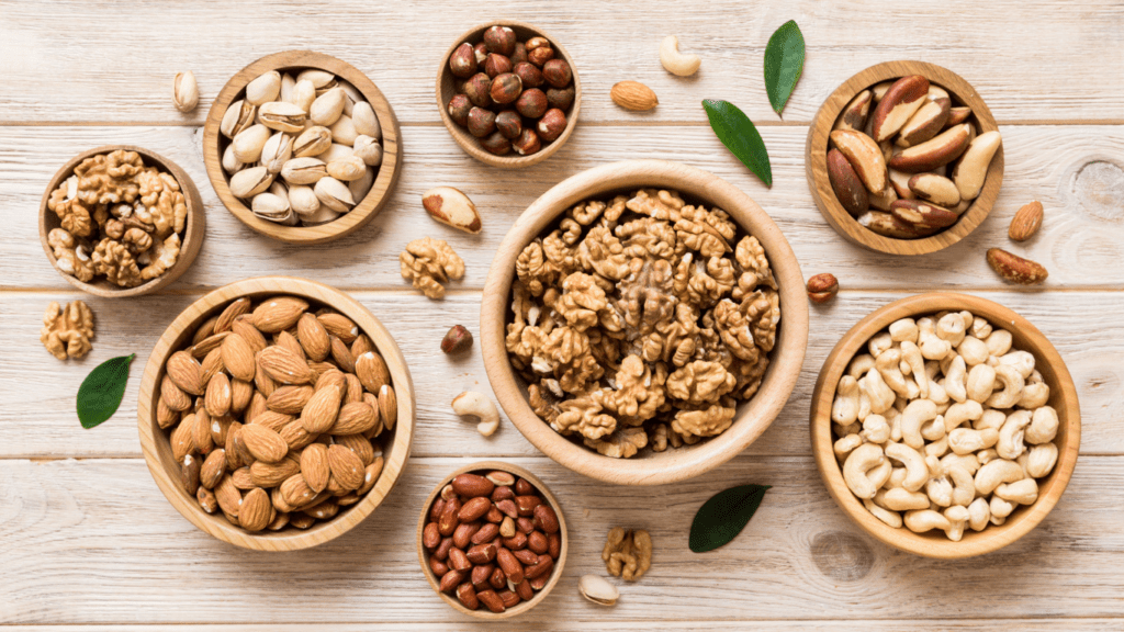 different types of nuts in bowls on a wooden table