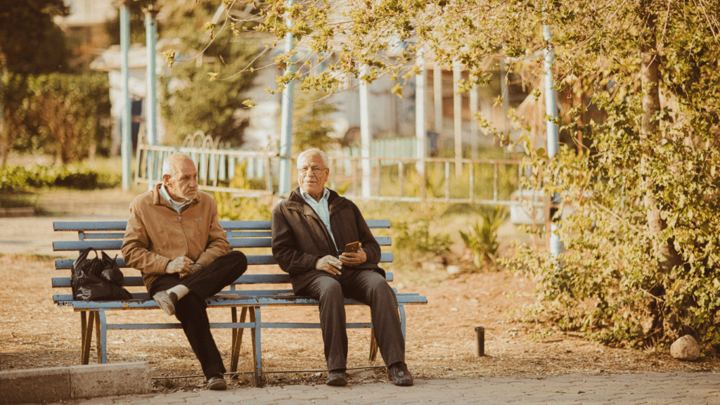 individuals sitting on a bench in a park