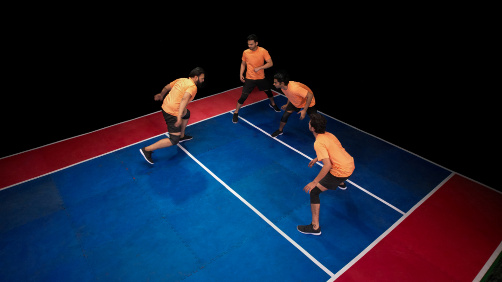 a group of people playing badminton on a court