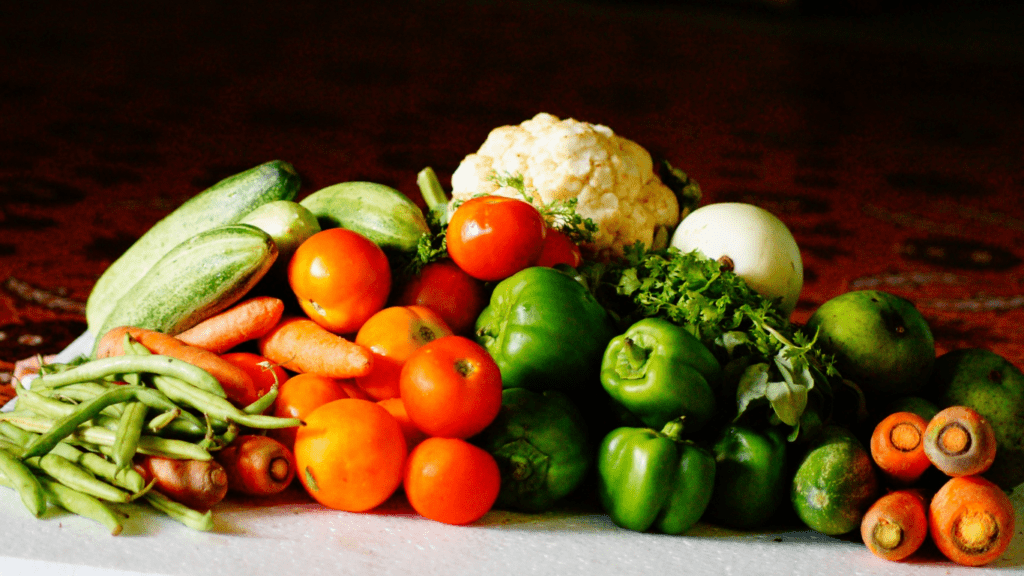 vegetables and fruits are arranged on a table