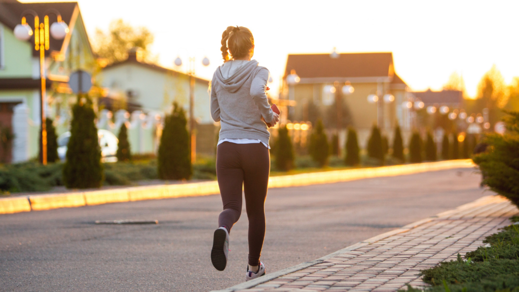 a person is jogging on a path in a park