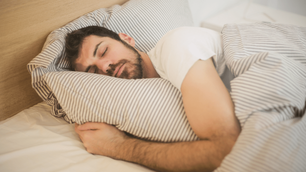 a person sleeping in bed with their eyes closed