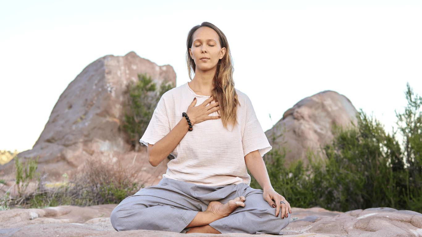 a person is meditating in the middle of the desert