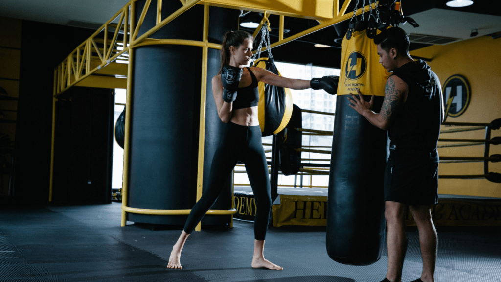 Two people in a gym with boxing gloves