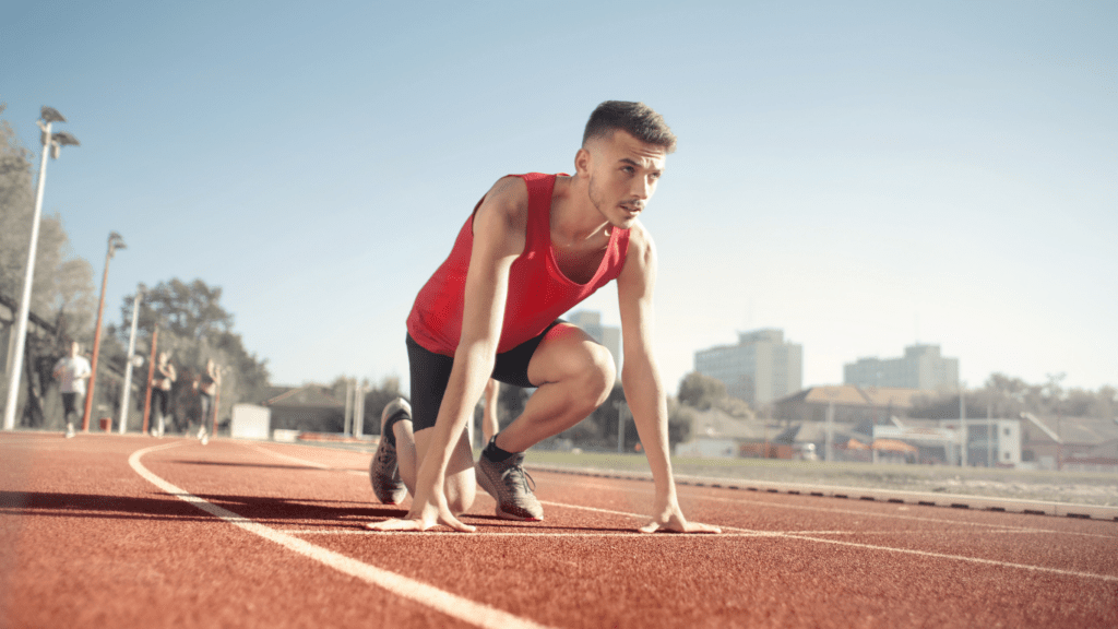 a person is starting their race on a running track