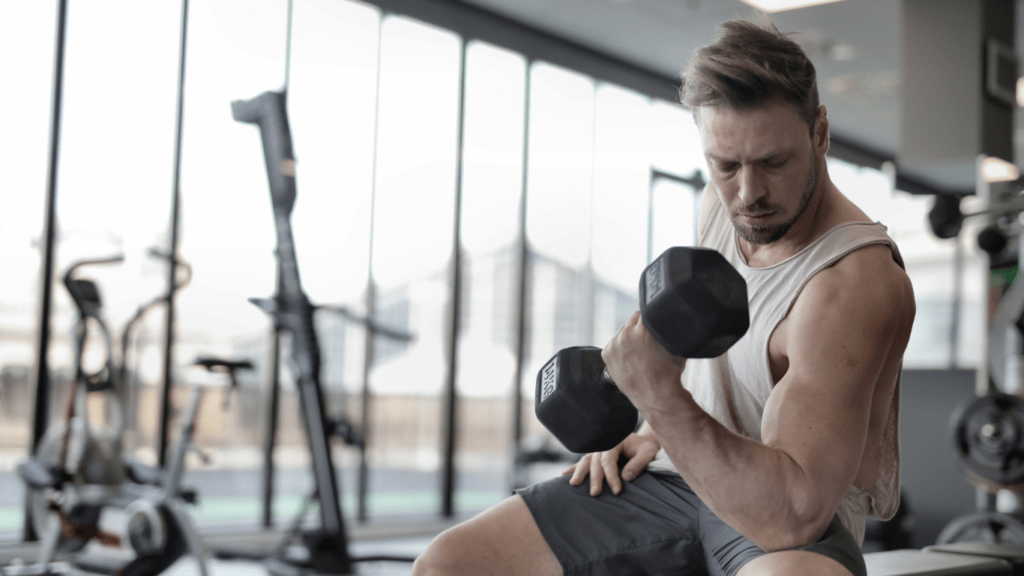 a person is working out with dumbbells in a gym