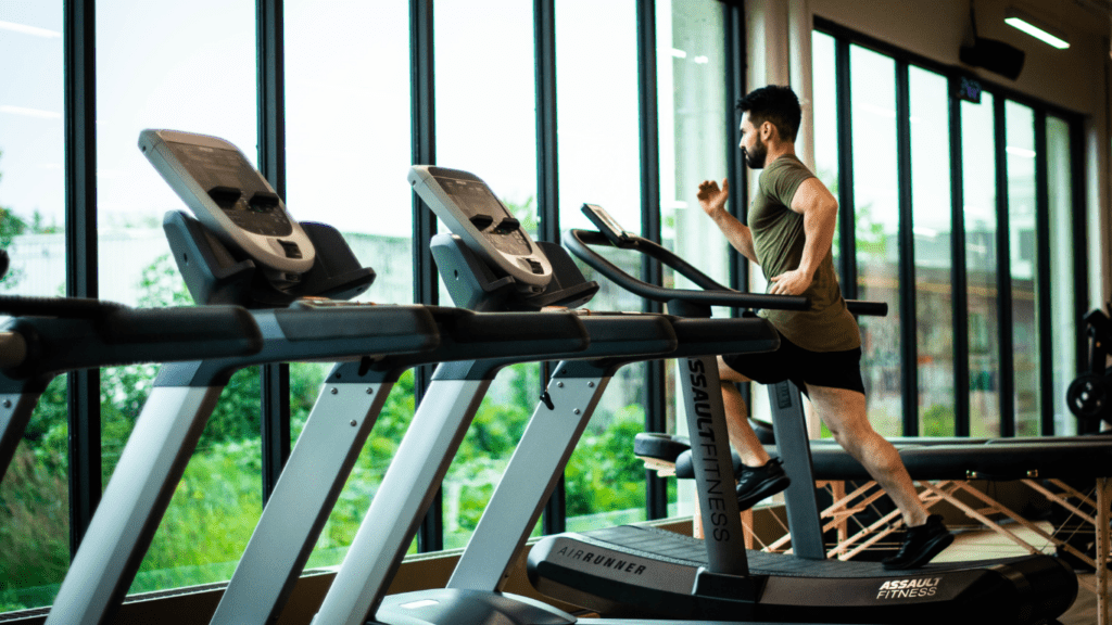 a person is running on a treadmill in a gym