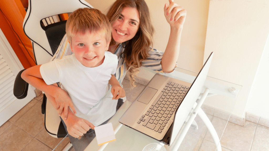 a person and a child in front of laptop