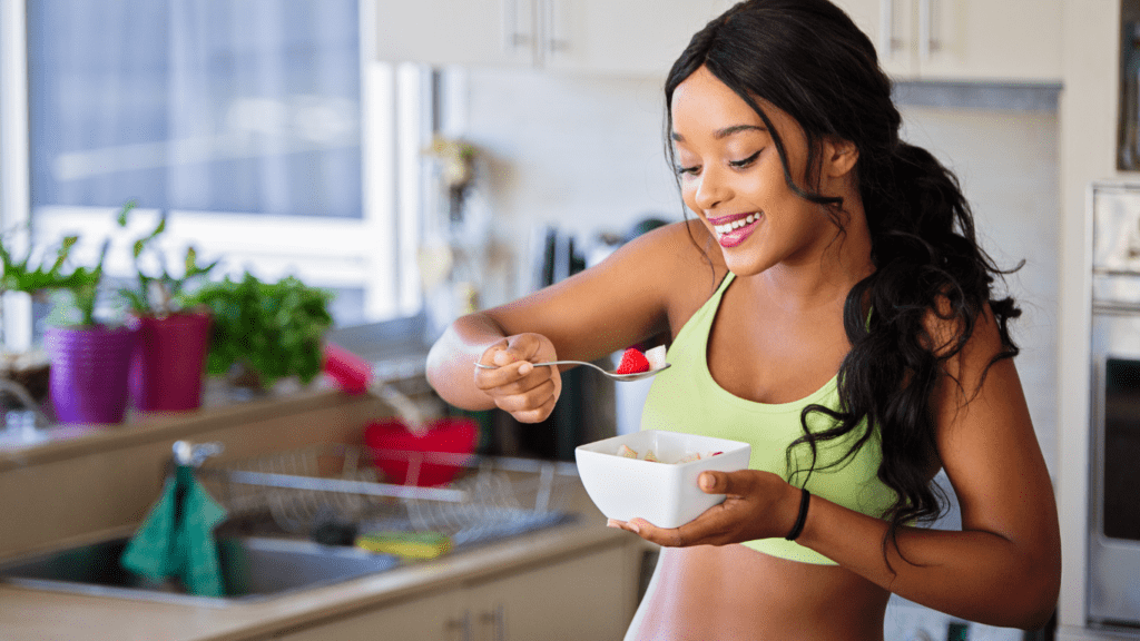 a person eating a bowl of cereal in the kitchen