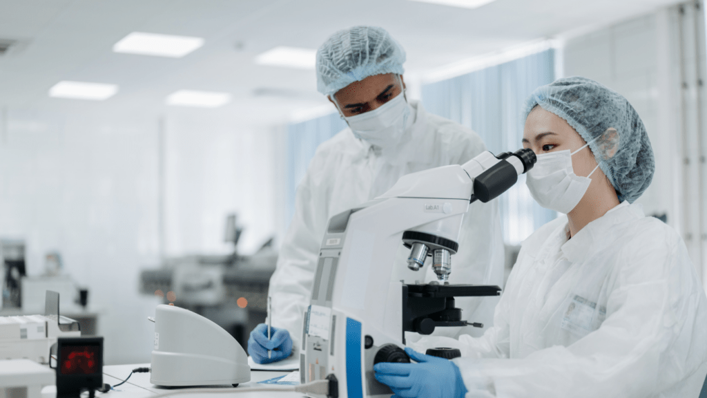 a person in a lab coat is using a microscope