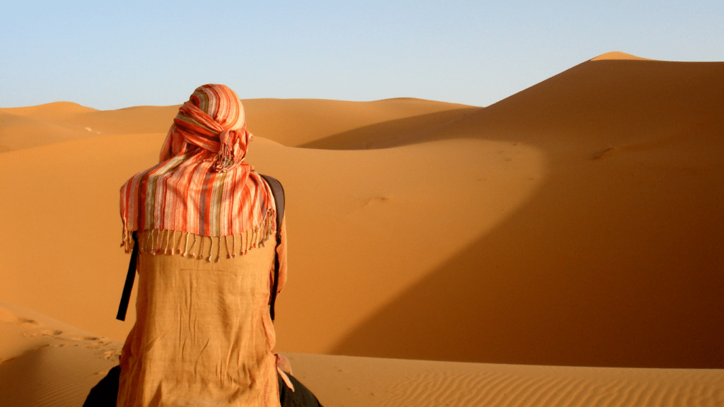 a person is meditating in the middle of the desert