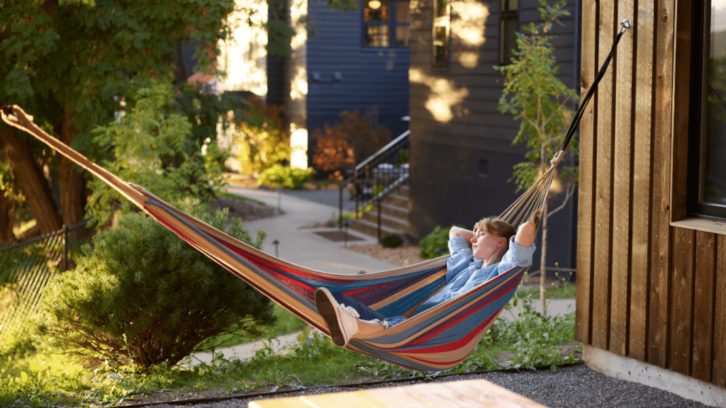 a person is relaxing in a hammock