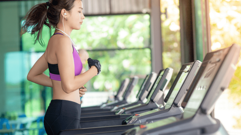 a person is running on a treadmill in a gym