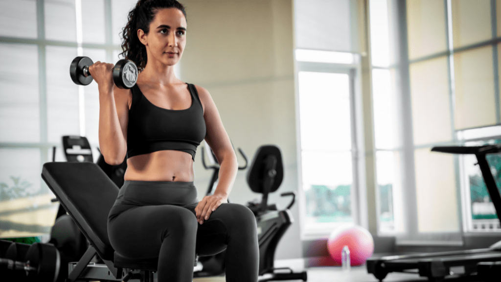 a person is working out with dumbbells in a gym