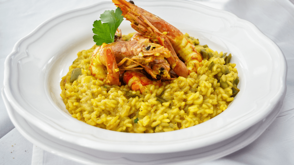 a plate topped with shrimp, rice and broccoli