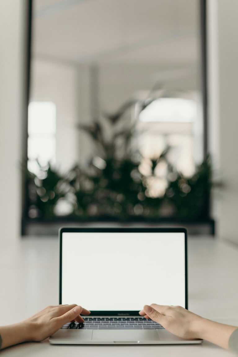 Photo of Person's Hands Using Laptop