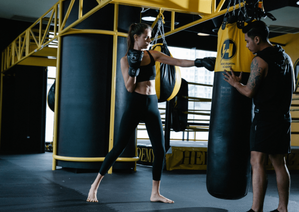 Two people in a gym with boxing gloves